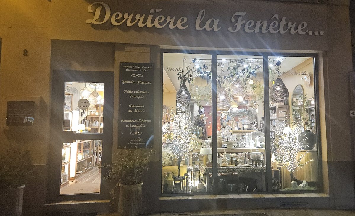 La devanture chaleureuse de Derrière la Fenêtre, enseigne dorée et vitrine illuminée